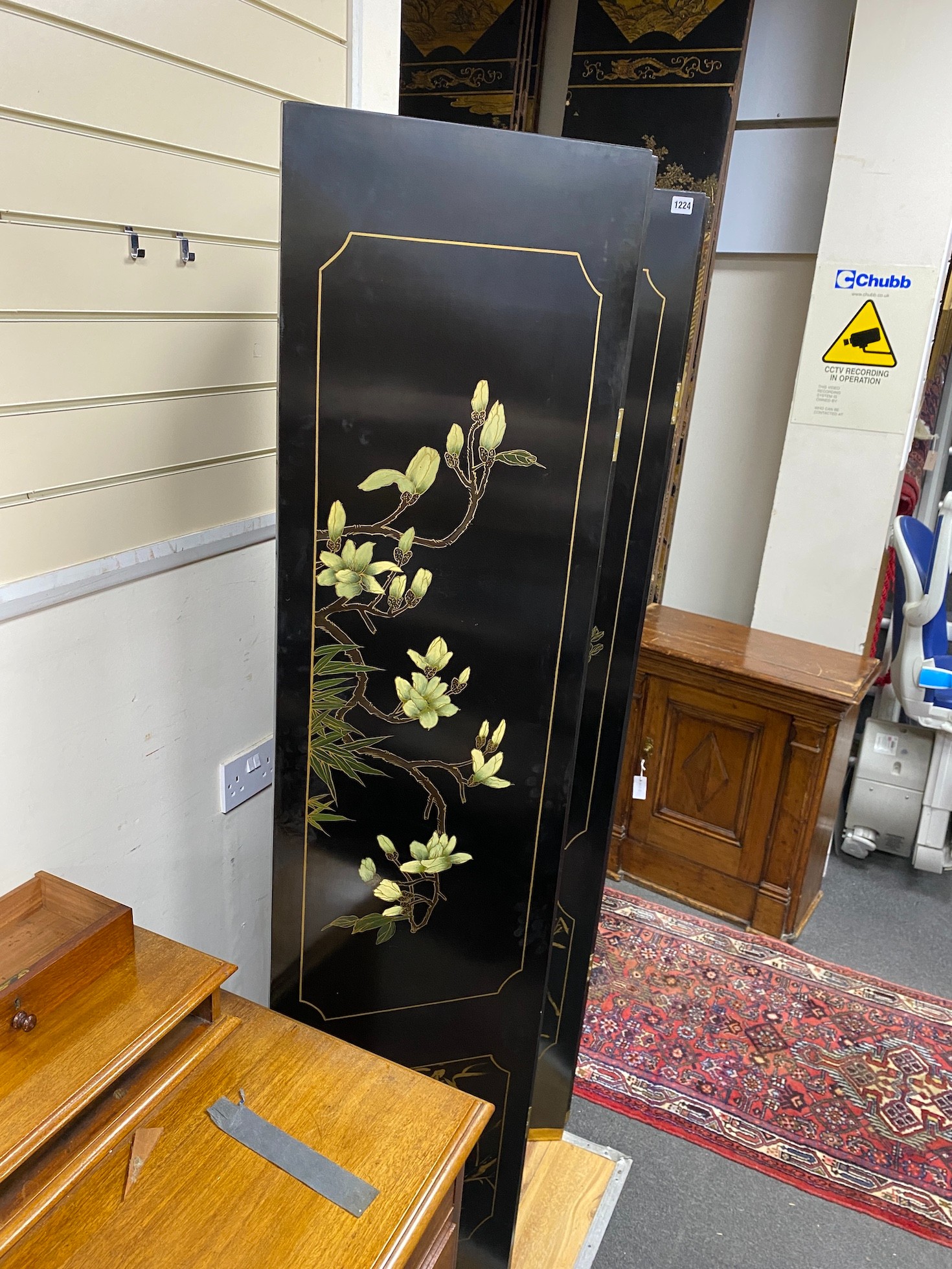 A Chinese lacquer four fold dressing screen, each panel width 40cm, height 184cm